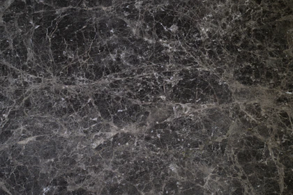 A detailed 8k texture image of black marble with fine veins, evoking luxury and depth.