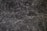 A detailed texture of dark marble with intricate white veining patterns running throughout the surface. The natural stone exhibits multiple shades of black and gray, creating an elegant and sophisticated appearance.