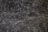 A detailed texture of dark marble with intricate white veining patterns running throughout the surface. The natural stone exhibits multiple shades of black and gray, creating an elegant and sophisticated appearance.