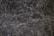 A detailed texture of dark marble with intricate white veining patterns running throughout the surface. The natural stone exhibits multiple shades of black and gray, creating an elegant and sophisticated appearance.