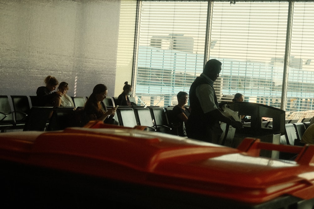 a group of people sitting at a table in an airport