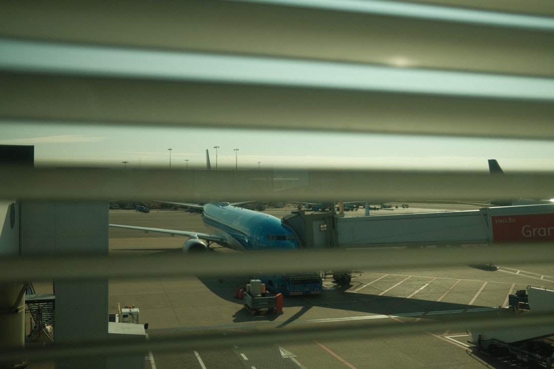 a large jetliner sitting on top of an airport tarmac, Airplane docking at an airport