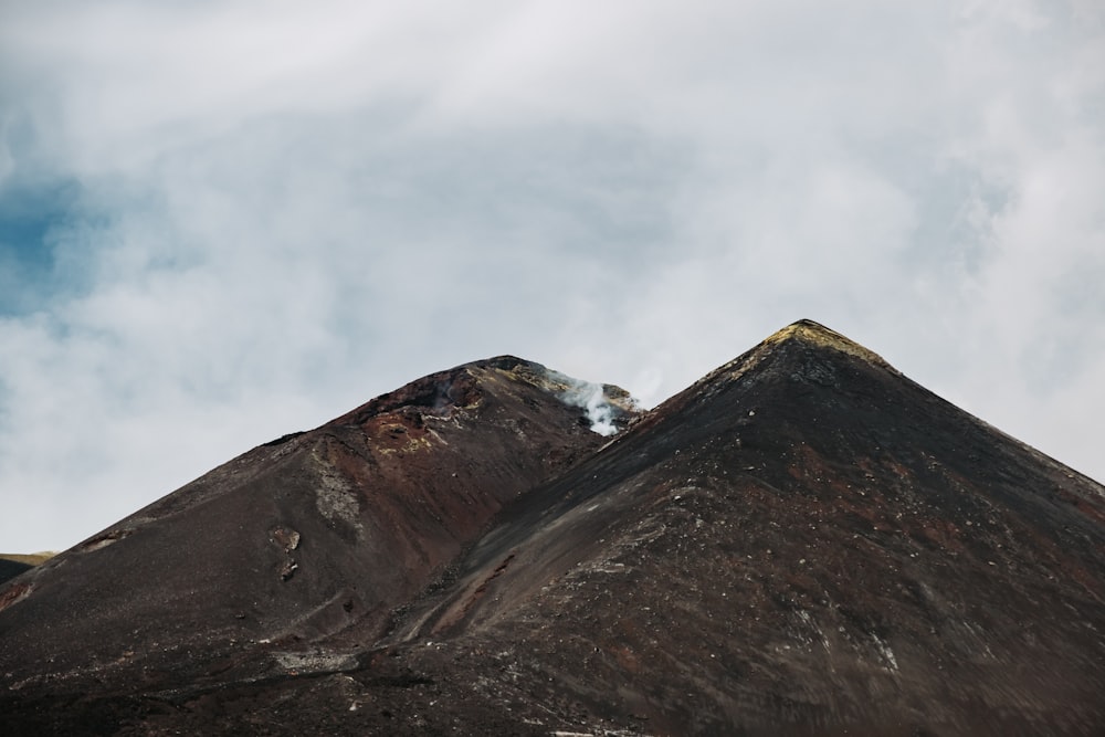 uma montanha com algumas nuvens no céu