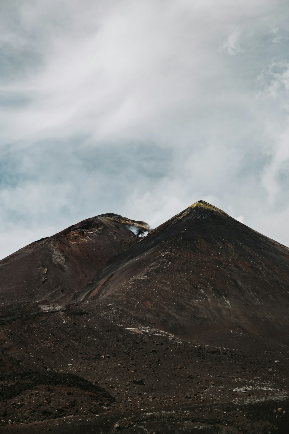 a very tall mountain with a sky in the background