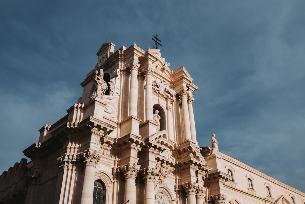 a tall building with a cross on top of it