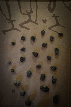 A textured wall blending earth tones and cultural motifs in a quiet urban space.