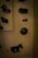Various dark, metal figurines of animals are displayed on a textured beige background. The figurines include an elephant, a donkey, and some other indistinct shapes. A decorative circular metal piece is also present.