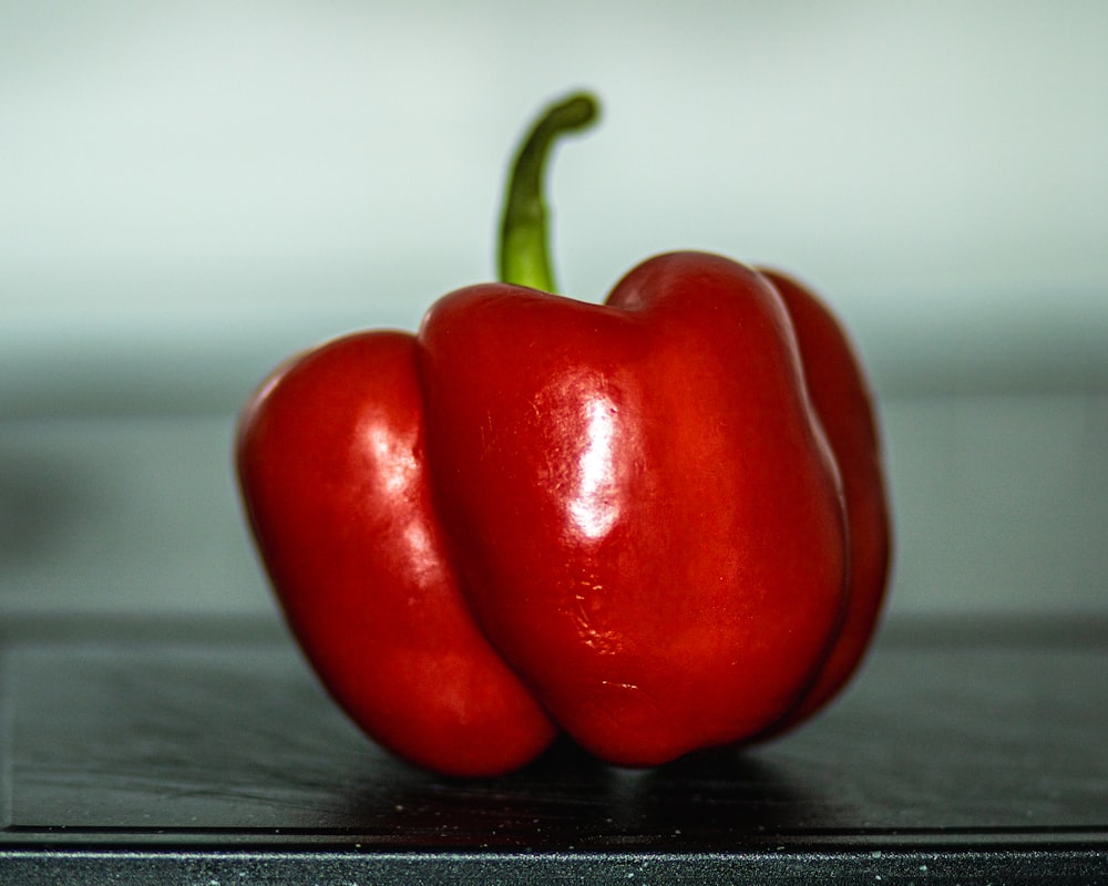a couple of red peppers sitting on top of a counter