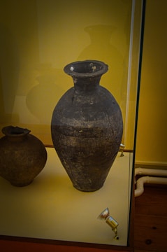 Technician analyzing a rare porcelain vase with specialized equipment.