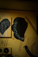 Close-up of detailed medieval religious artifacts and faction symbols from the Mortras universe.