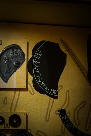 Close-up of detailed medieval religious artifacts and faction symbols from the Mortras universe.