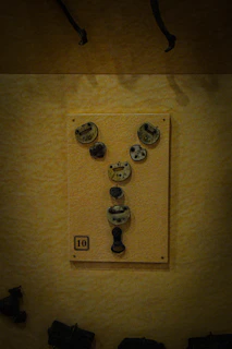 A neat display of various keys and locks arranged on a rustic wall in the workshop.