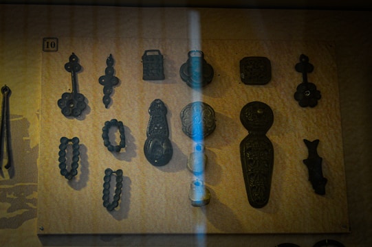A collection of laser-cut astronomy-themed objects displayed on a wooden table.