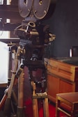 A close-up of a vintage film camera on a tripod.