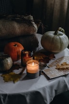 An inviting cozy scene with autumn leaves and warm scarves arranged on a rustic table.