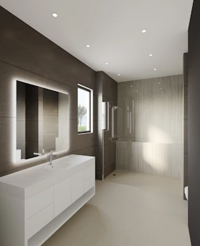 A well-organized bathroom featuring clean lines and high-quality fixtures with natural light.