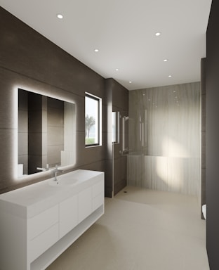 Modern bathroom with clean white tiles and a large mirror.