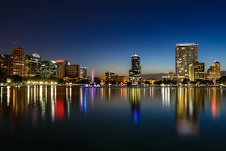a view of a city at night from across a lake