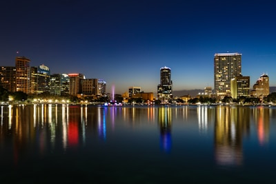 a view of a city at night from across a lake