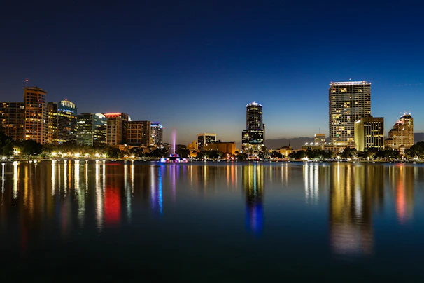 a view of a city at night from across a lake