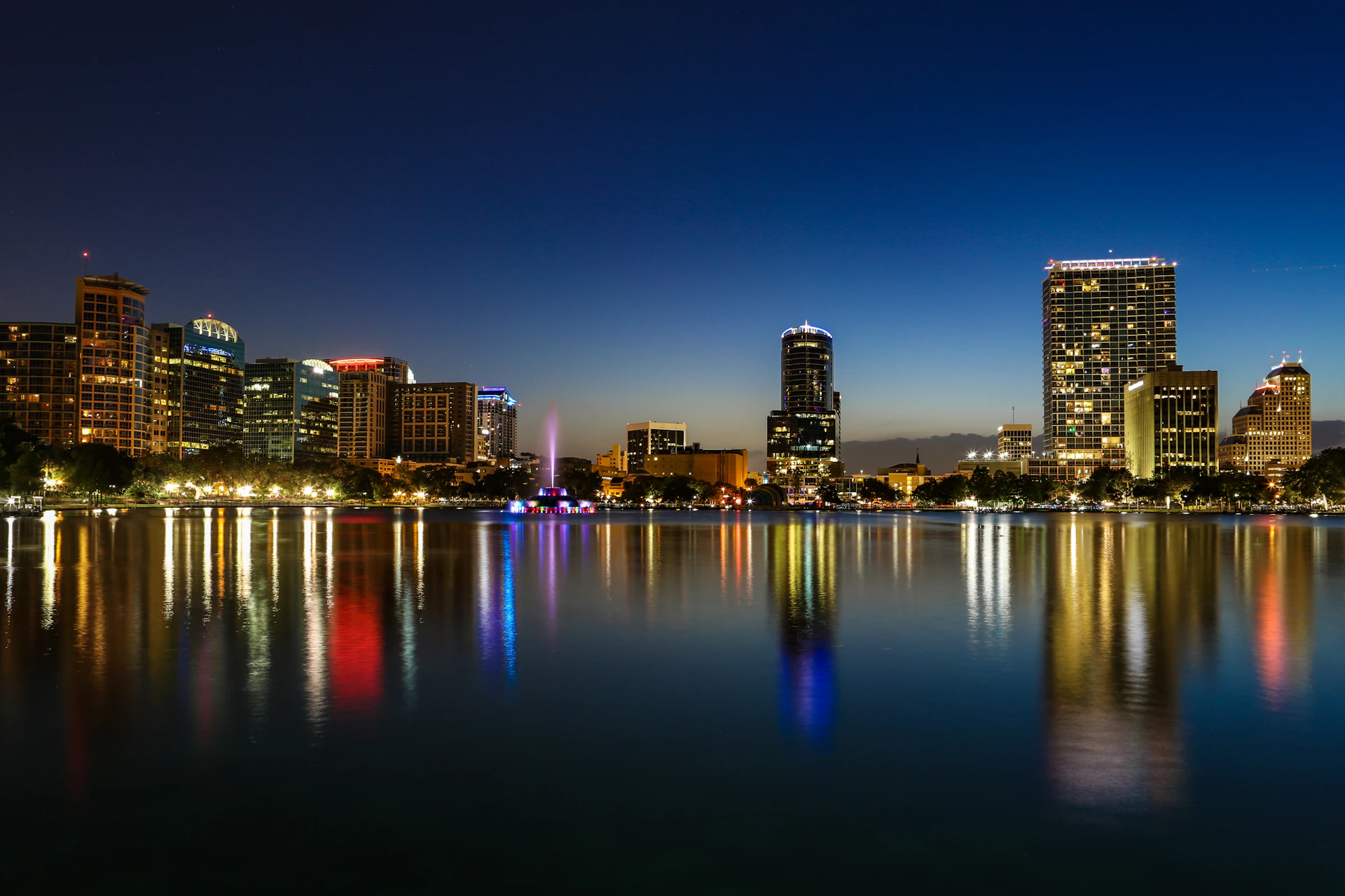 a view of a city at night from across a lake