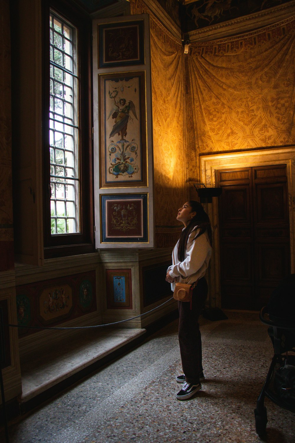 a woman standing in front of a window in a room