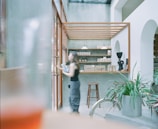 View of the café counter with natural plants and minimalist design elements.