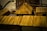 Wooden model buildings featuring log cabin construction and prominent plank roofs dominate the scene. The craftsmanship displays detailed joints and fittings that reflect traditional architecture. The structures are arranged in a way that suggests a small village or settlement.