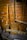 A variety of old wooden tools are displayed against a wooden wall. The tools include large paddles and wooden handles, possibly used for agricultural or manual tasks. The wood has a weathered look, indicating age and use.