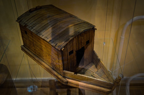 A handcrafted ark model adorned with symbols from all three faiths, set against Himalayan backdrop.