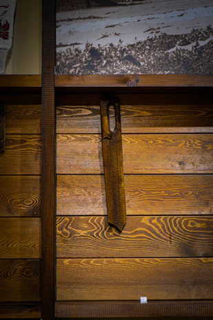 Custom wooden wall art featuring natural wood grain and laser-cut design hung on an off-white wall.