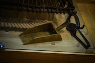 Historic mining tools and relics displayed on a weathered wooden table.