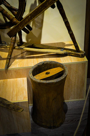 Fresh cow milk being churned in a wooden butter churner in a sunlit kitchen