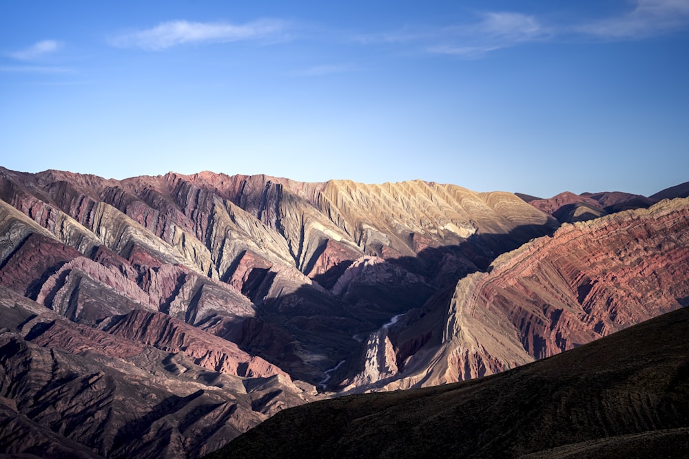 a view of a mountain range from the top of a hill