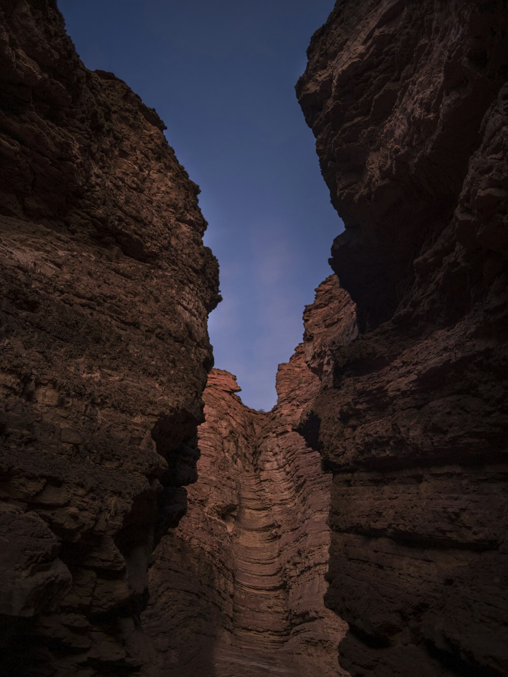 a narrow path between two large rocks