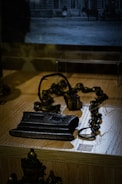 A broken chain lying on a weathered wooden table symbolizing liberation.