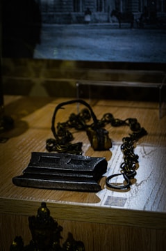 A broken chain lying on a weathered wooden table symbolizing liberation.