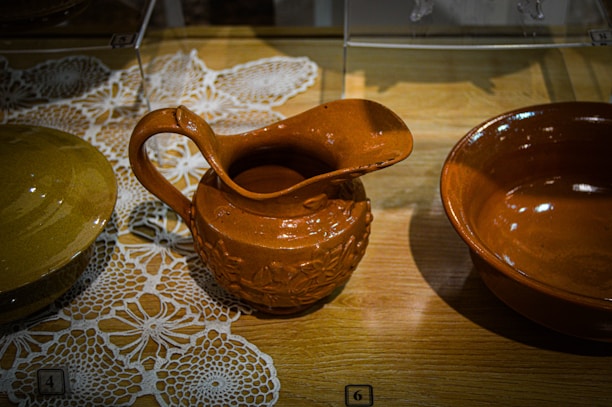 Close-up of traditional Slovak pottery displayed on a wooden table.