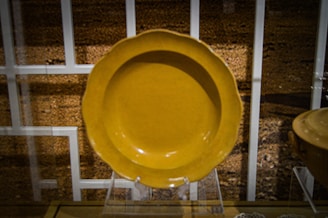 A close-up of rare triangular and round plates carefully displayed for auction.