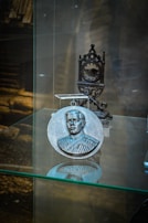 A shiny medal engraved with radio waves and call signs displayed on a velvet cushion.