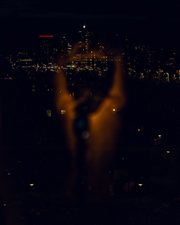 A shadowy cityscape at night, symbolizing discreet surveillance work.