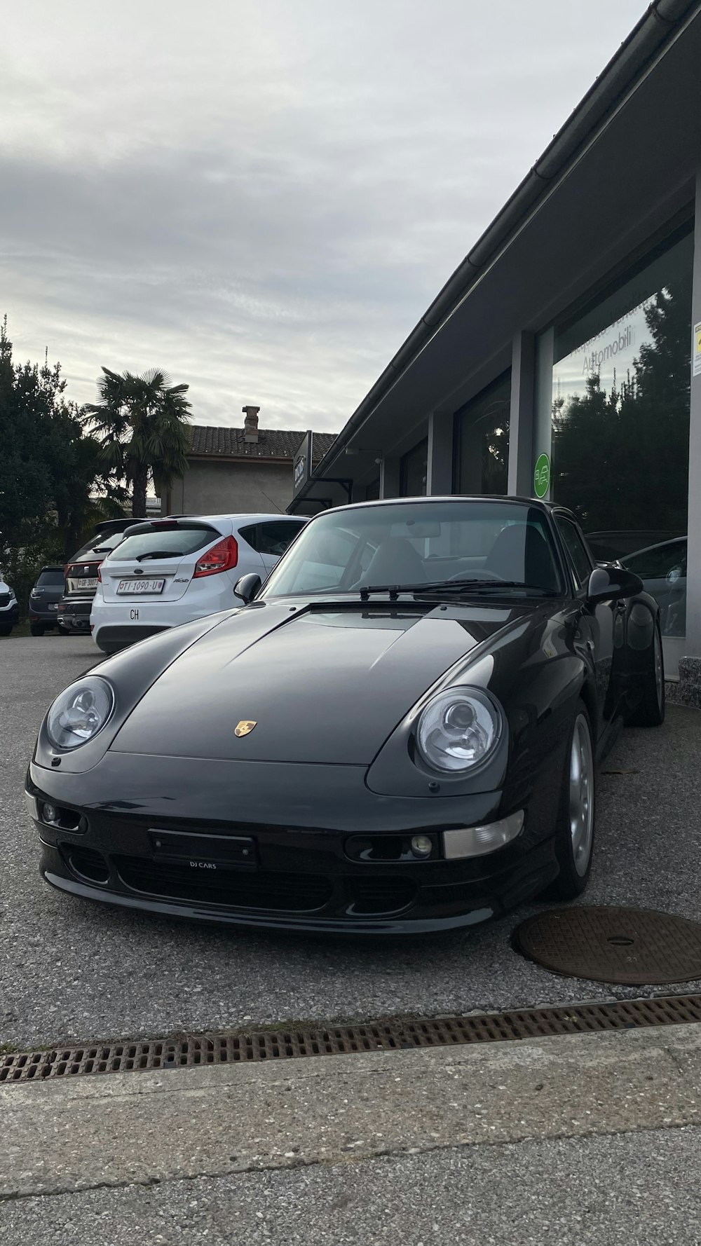 a black sports car parked in front of a building