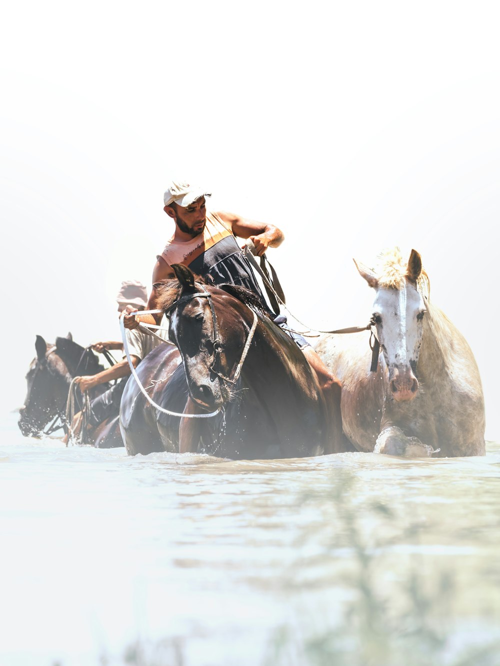 a man riding on the back of a brown horse