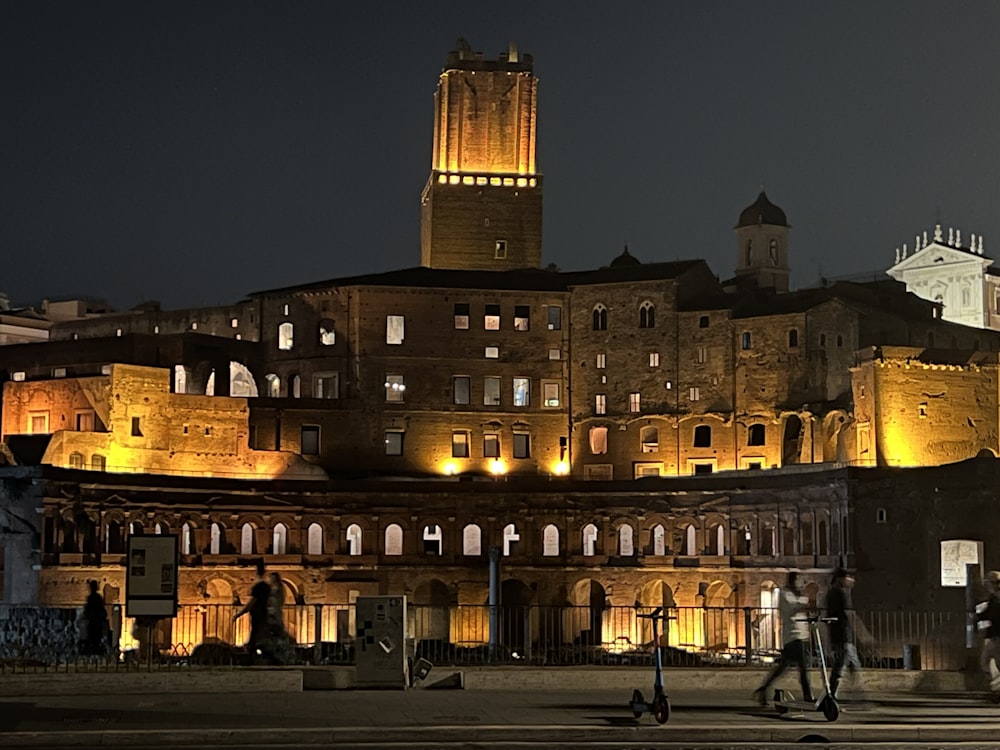 a large building with a clock tower lit up at night