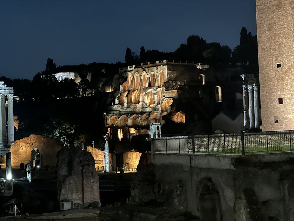 a night time view of a city with a clock tower