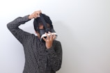 a man is holding a paper bag over his head