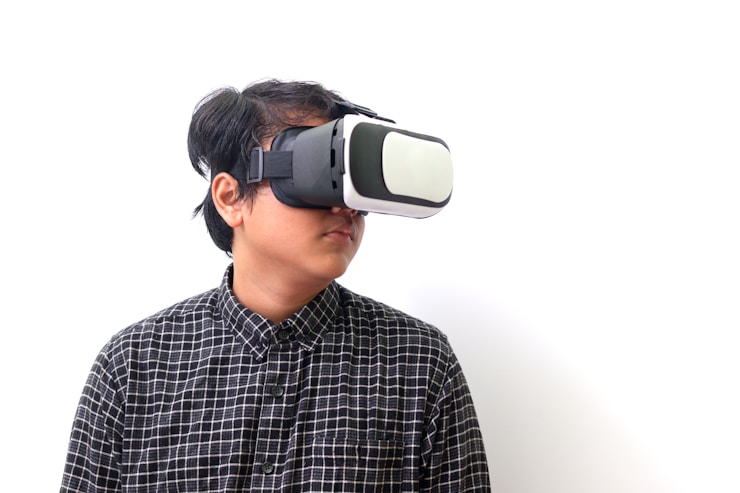 Asian man using Virtual Reality VR glasses and playing games