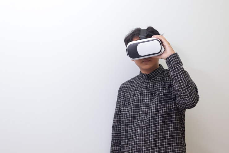 Asian man using Virtual Reality VR glasses and playing games