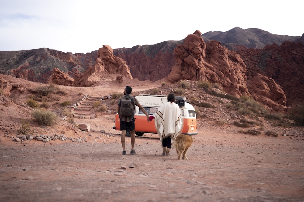 a couple of men standing next to a van