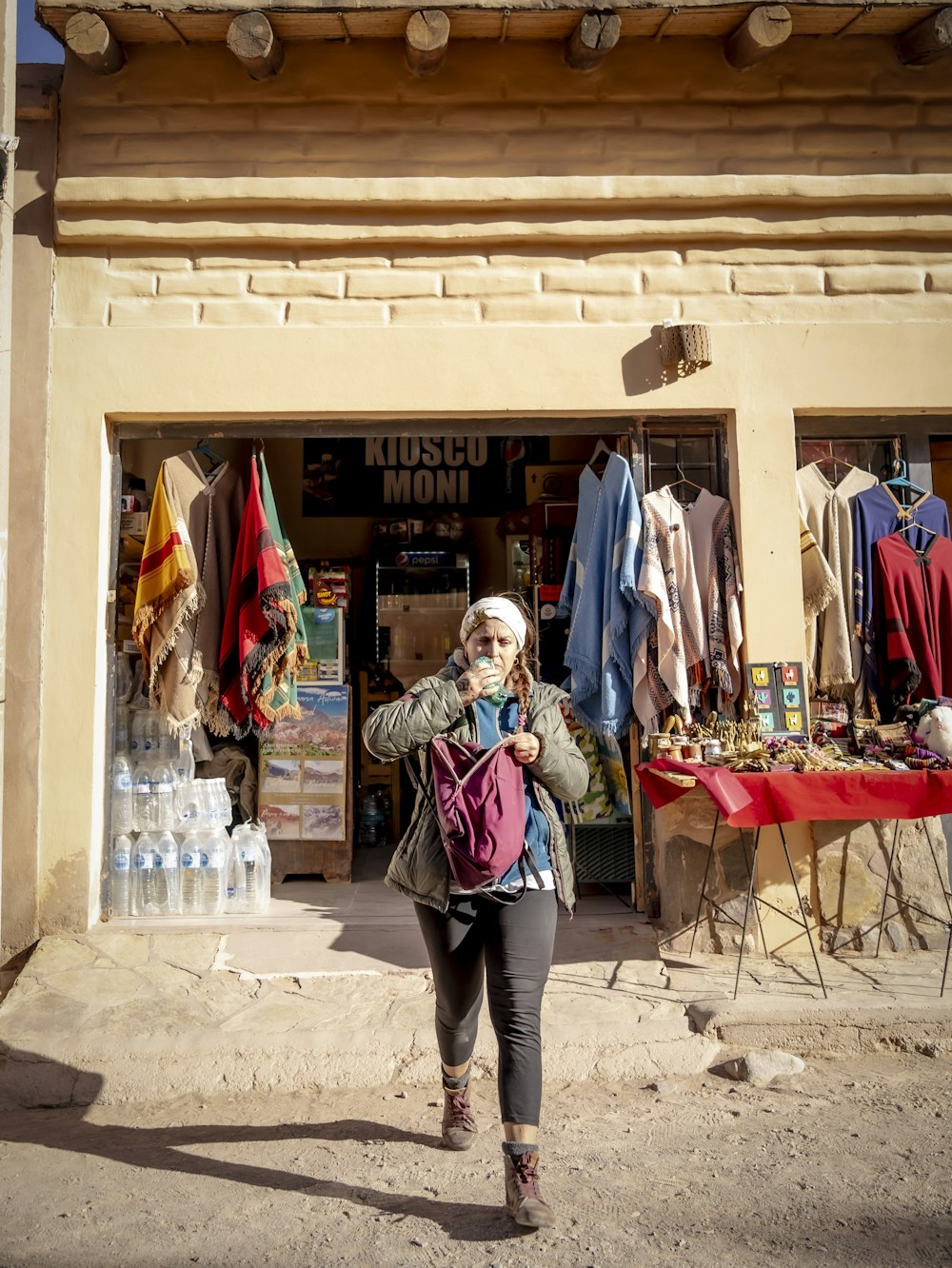 a woman standing in front of a clothing store